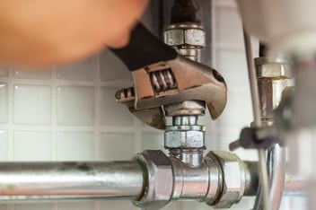 Deferred maintenance- repairing pipes with wrench